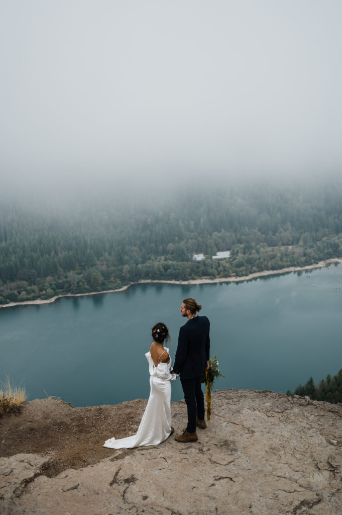 Couple posing at the top of Rattlesnake Ledge during their hiking elopement in Washington State