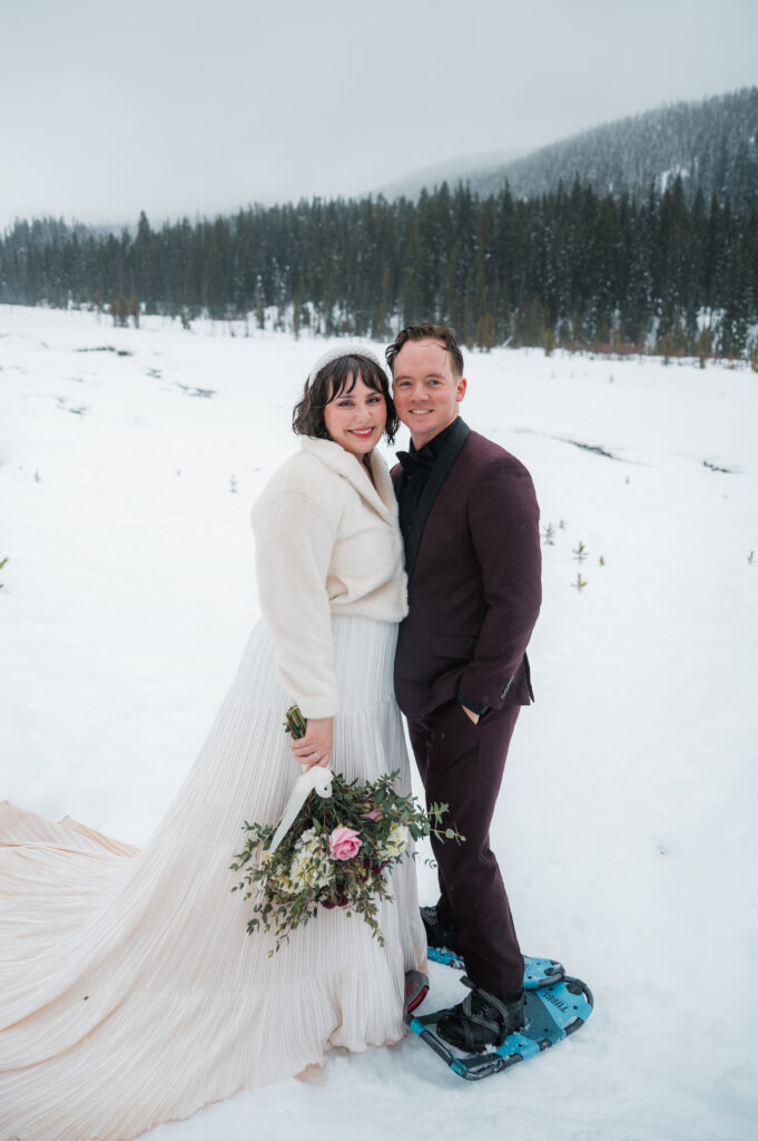 couple snowshoeing during their elopement day at Mount Hood in Oregon in the winter