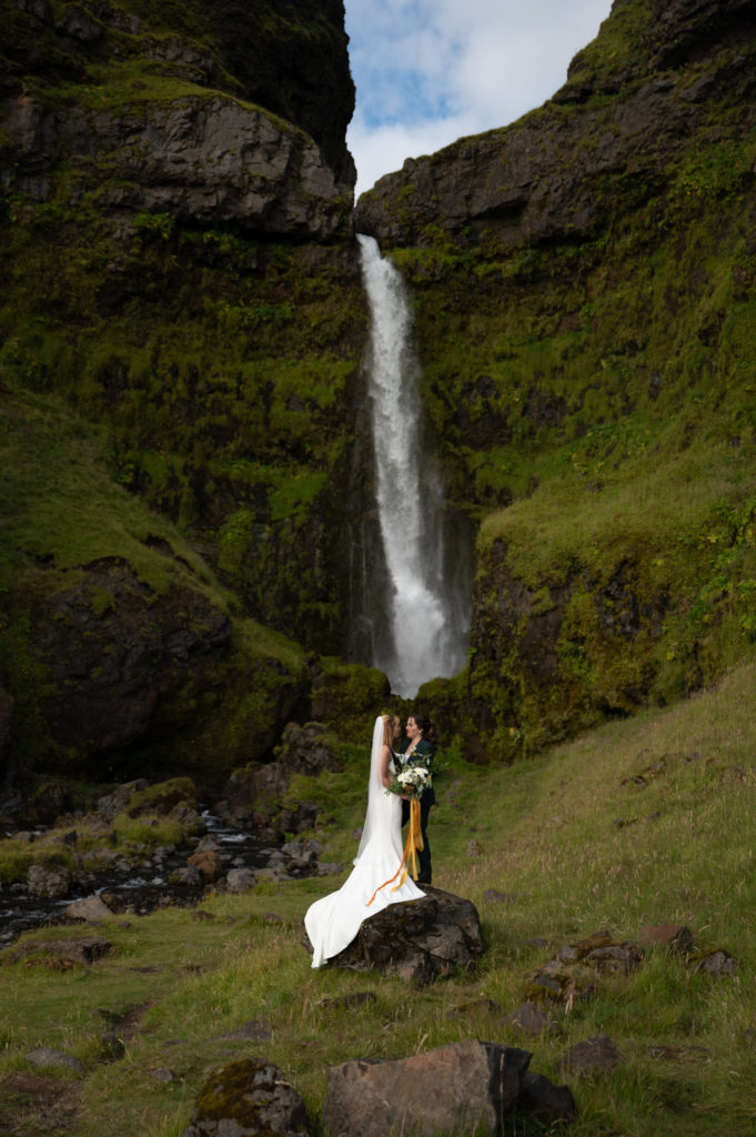 Couple eloping in front of a secret waterfall in Iceland