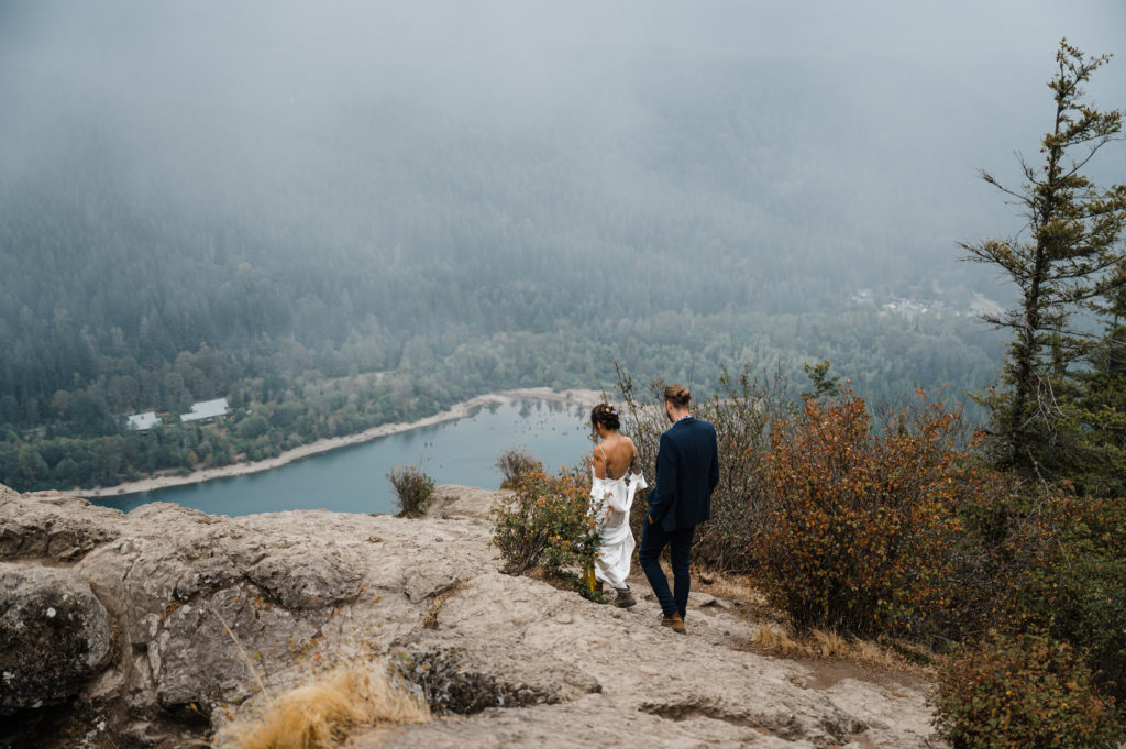 Couple hiking at the top of Rattlesnake Ledge during their adventure elopement in Washington State