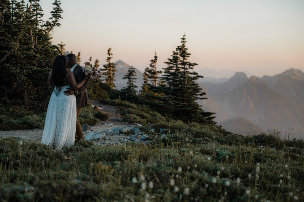 Bride and groom surrounded by wildflowers during their elopement at Mount Rainier National Park