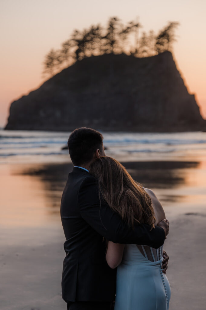 couple watching the sunset at second beach in olympic national park