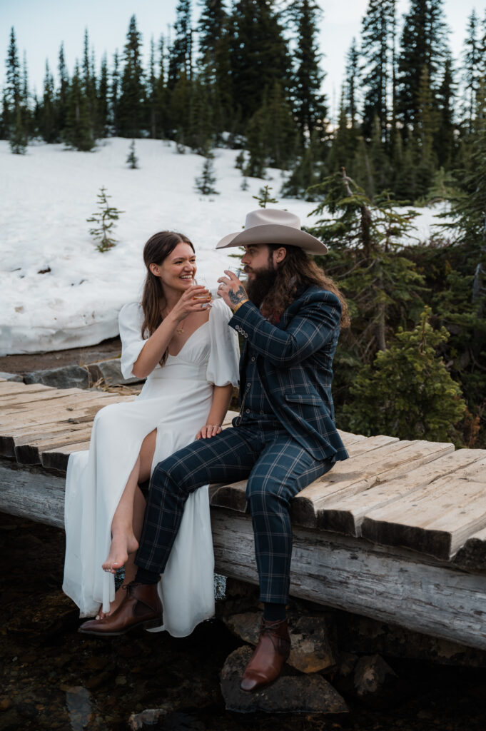 couple drinking whiskey shots after their wedding ceremony at mount rainier national park