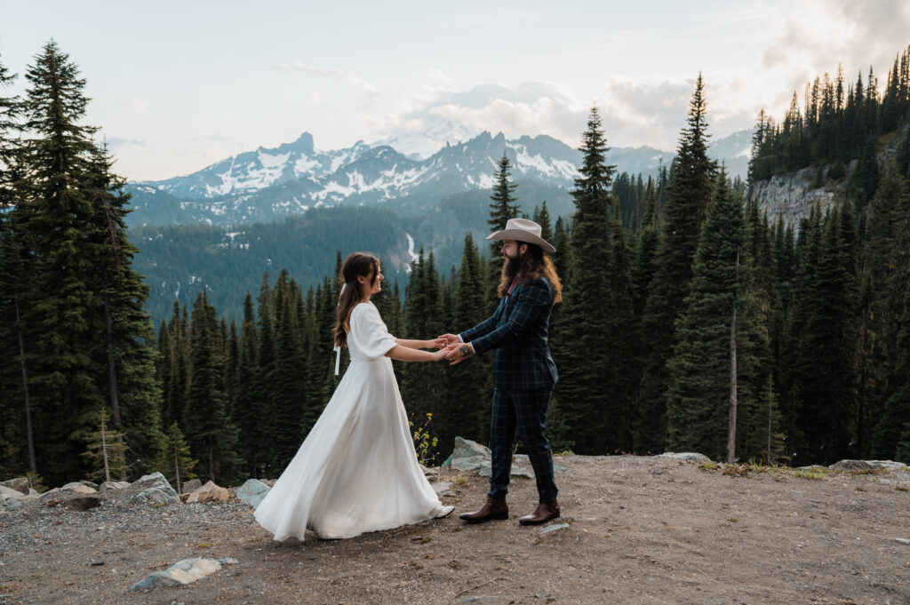 Bride and groom having their first dance with mount rainier in the background 