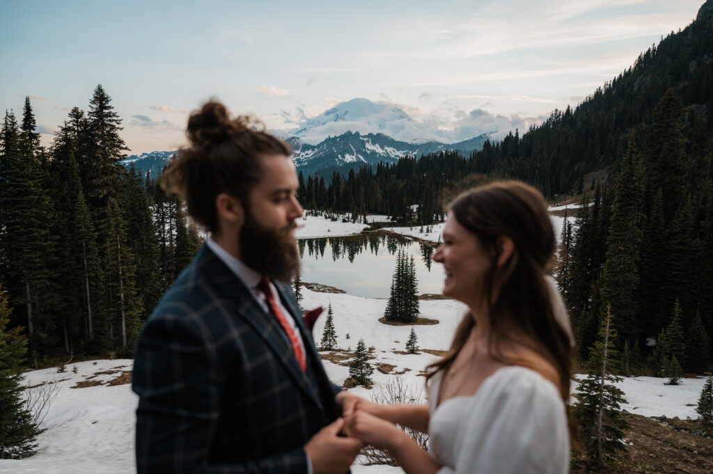 Couple saying their vows with views of Mount Rainier in the background during their elopement in Washington State