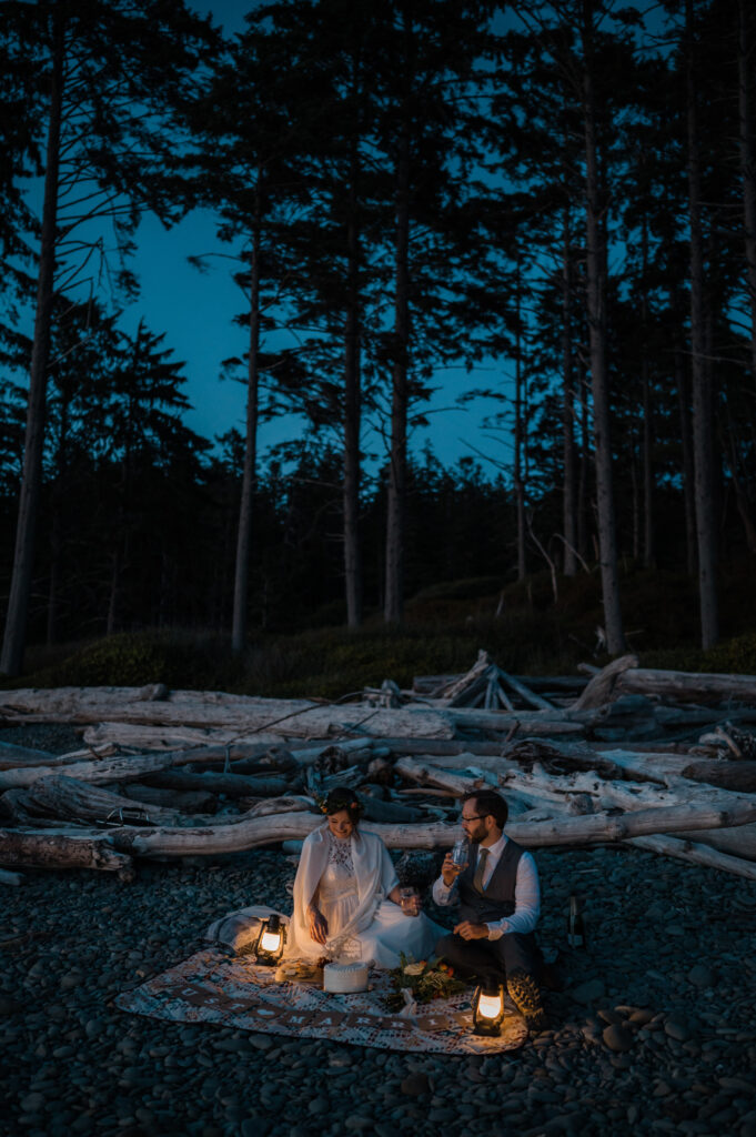 Couple having a picnic after sunset at Ruby Beach on their elopement day in Olympic National Park