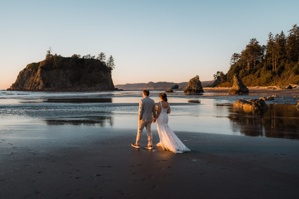 couple holding hands and walking at Ruby Beach during their elopement