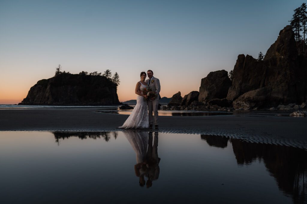 sunset reflection of the bride and groom at Ruby Beach