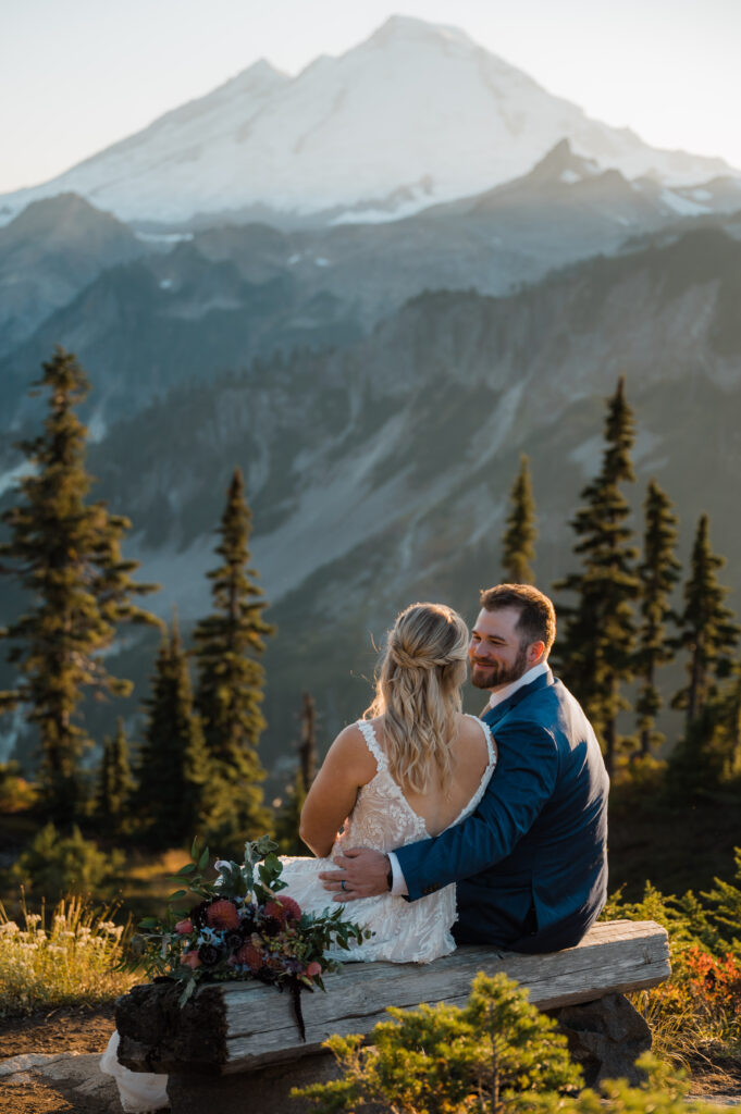 Bride and groom sitting together admiring the view of Mt. Baker during their elopement day