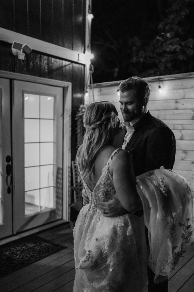 Bride and groom sharing their first dance at their cabin