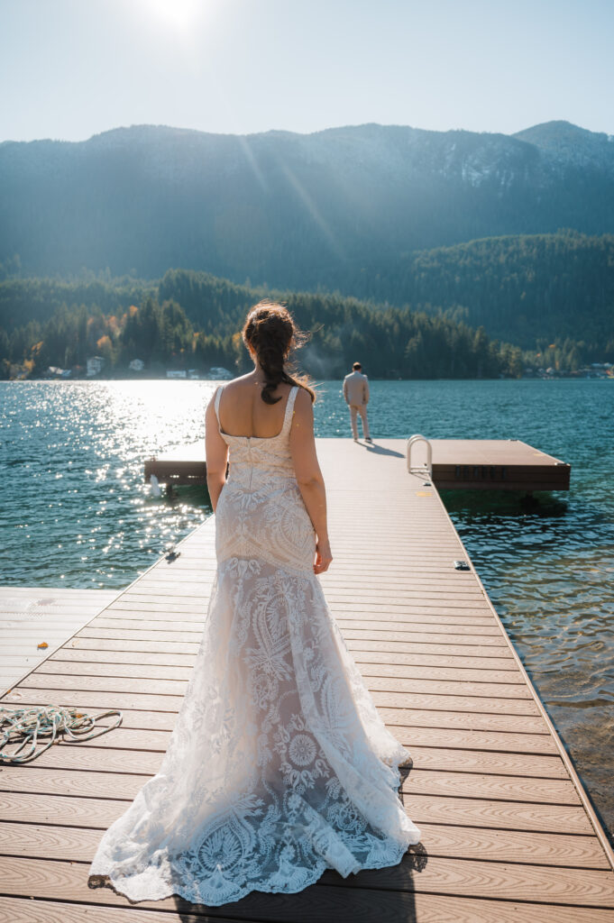 bride and grooms first look on the dock of their airbnb at Lake Sutherland in Olympic National Park