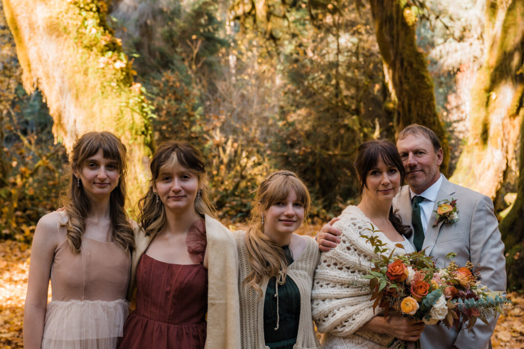 Couple posing with their daughters on their elopement day in Olympic National Park