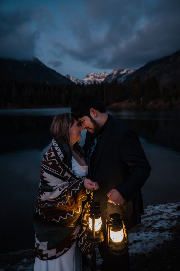 Bride and groom sharing an intimate moment at Gold Creek Pond with lanterns