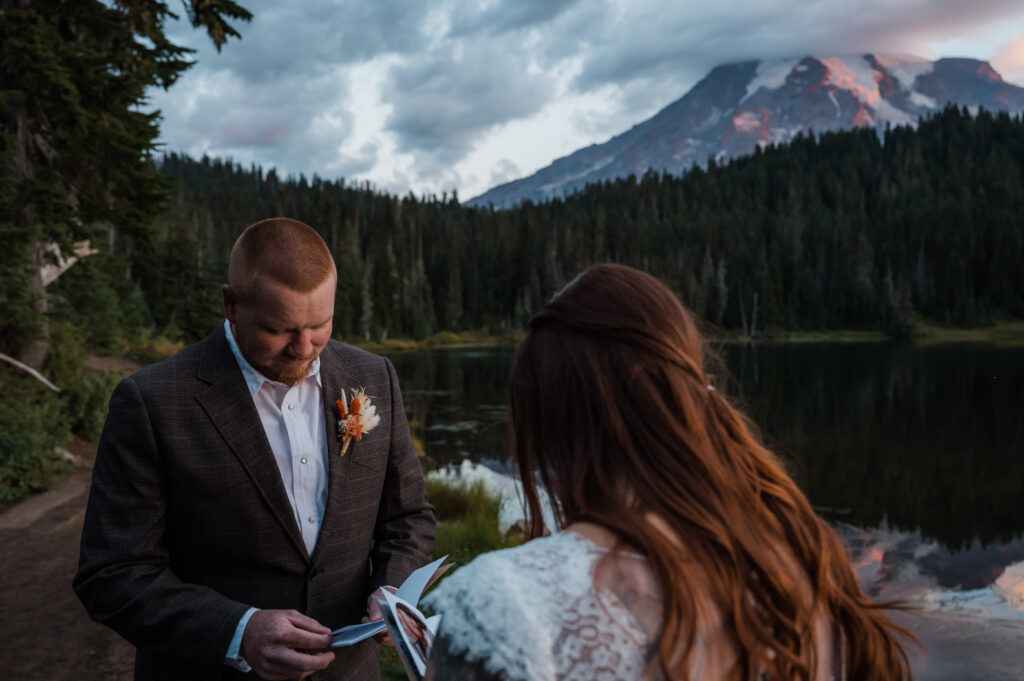 Groom saying his vows with views of Mount Rainier in the background 