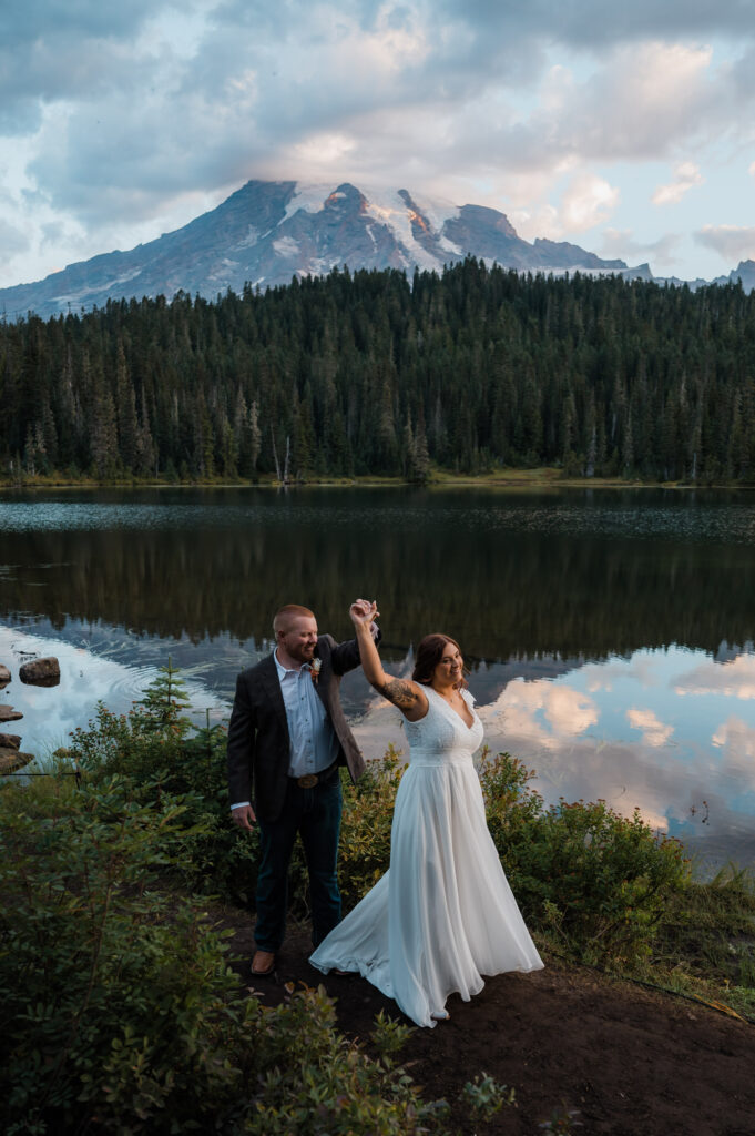 Couple dancing in front of Reflection Lake with views of Mount Rainier in the background 