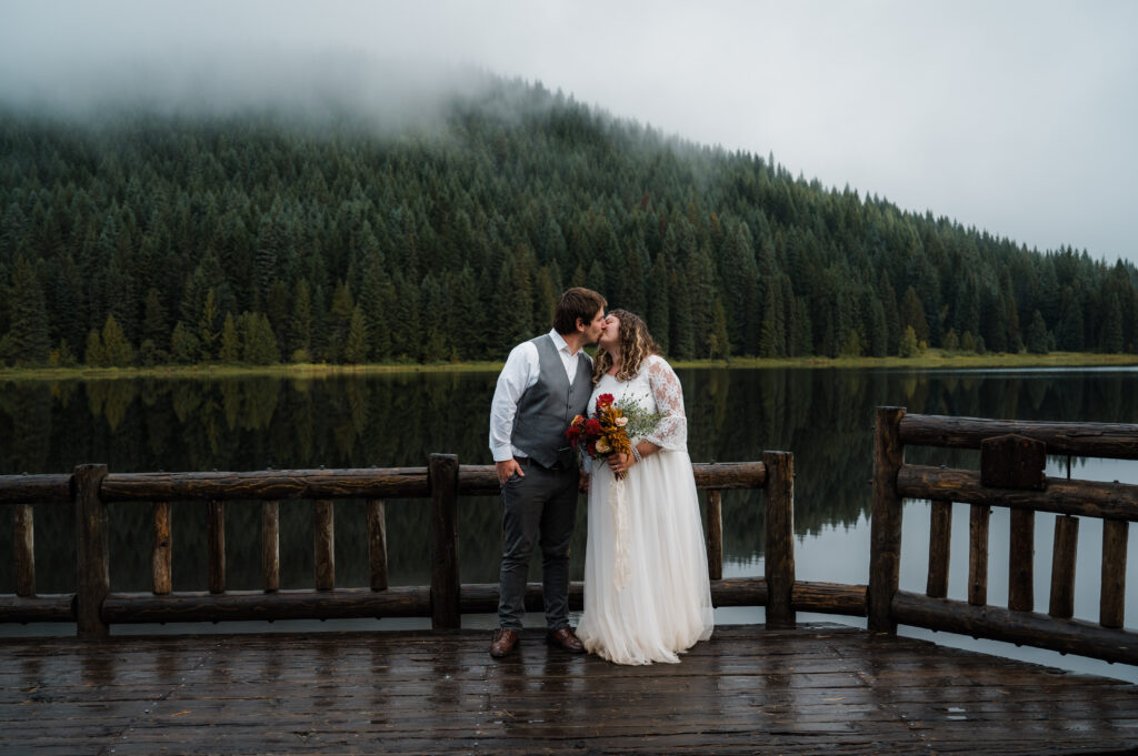 bride and groom sharing their first kiss after their elopement ceremony at Trillium Lake