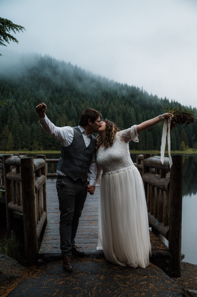 bride and groom celebrating with a kiss after their elopement ceremony at Trillium Lake