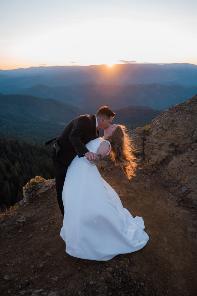 Bride and groom sharing their first dance as the sun rises over the mountians in Washington state