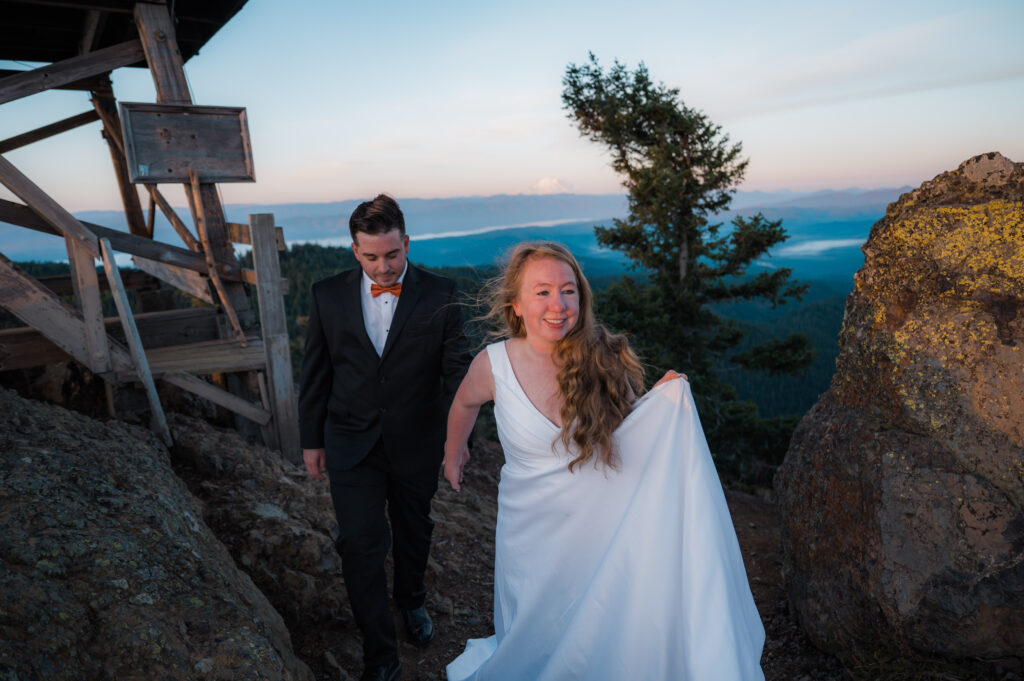 Newly married couple hiking up to a fire lookout in Washington State