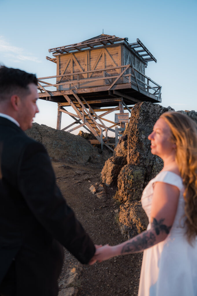 Bride and groom in front of the Red Top Fire Lookout near Leavenworth, Washington