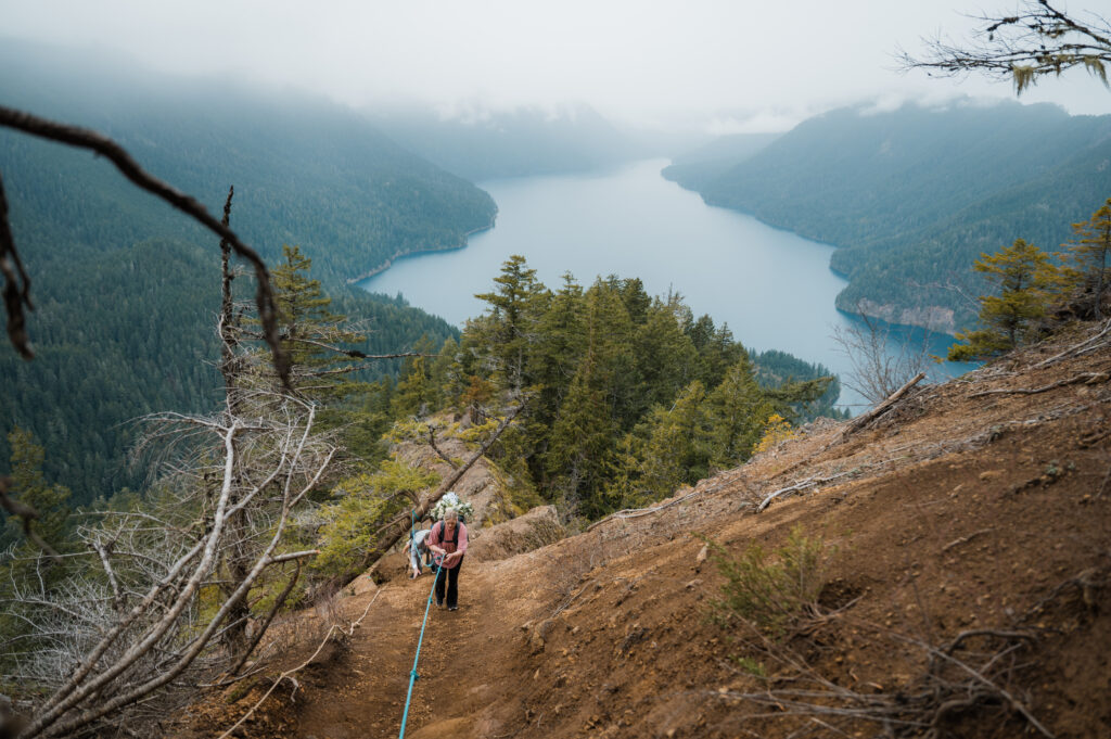 bride using ropes to climb up Mount Storm King in Olympic National Park