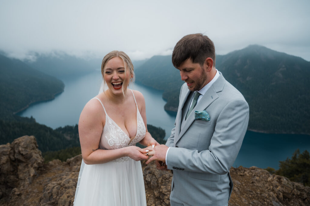 couple exchanging rings during their wedding ceremony on top of Mount Storm King in Olympic National Park