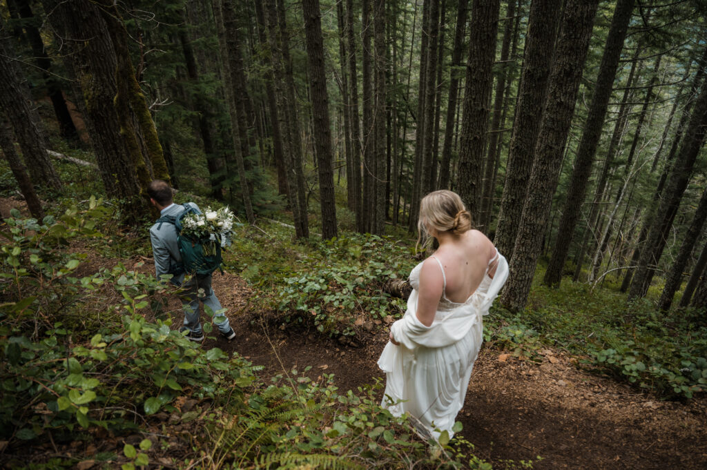 bride and groom hiking through the forest during their elopement day in Olympic National Park