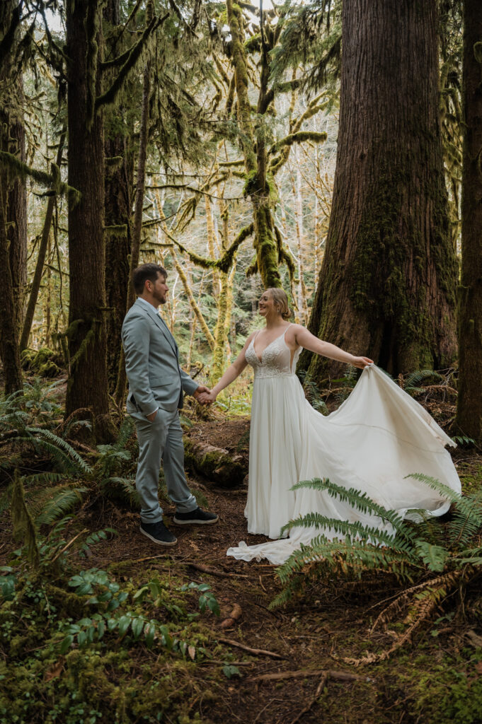 bride and groom posing for photos with mossy trees in Olympic National Park