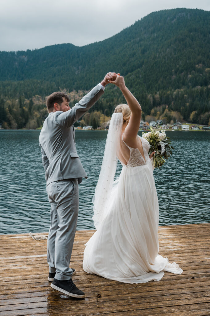 newly married couple sharing their first dance on the dock of their airbnb in Olympic National Park