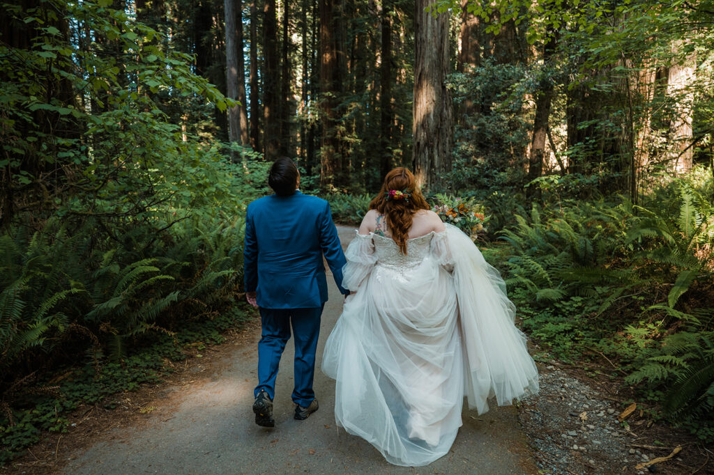 Bride and groom walking to their Redwood forest elopement ceremony