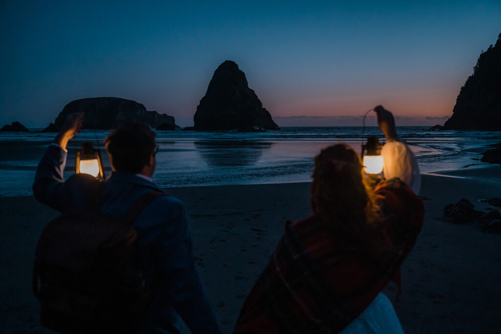 Couple walks along the beach with lanterns