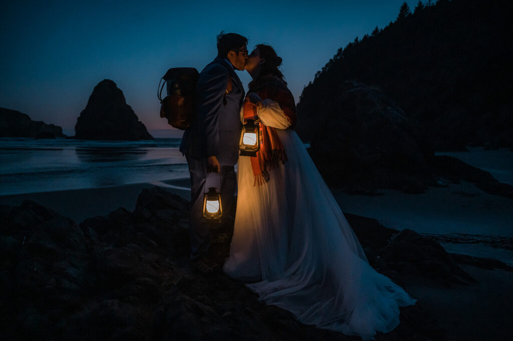 Couple walks along the beach with lanterns