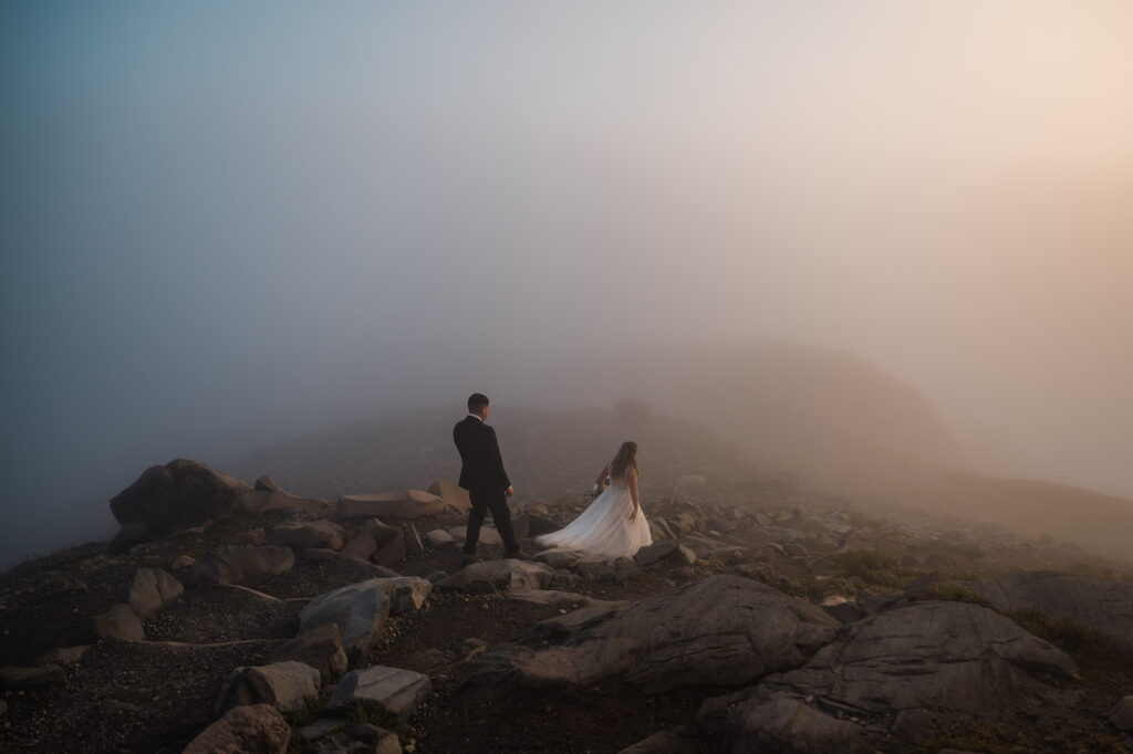 Bride and groom hike back down Skyline Trail with lanterns