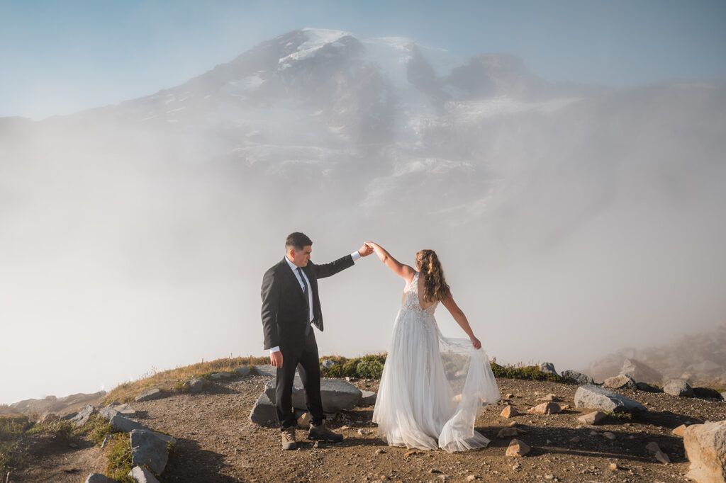 Bride and groom celebrate clear skies with a little dancing on Skyline Trail