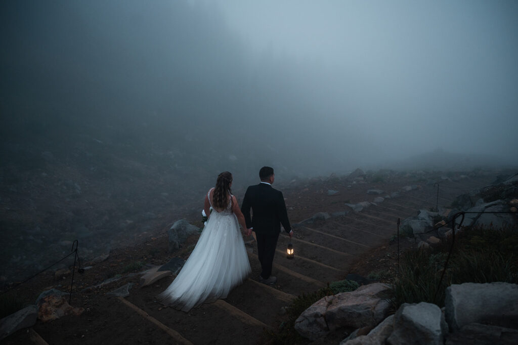 Bride and groom hike back down Skyline Trail with lanterns