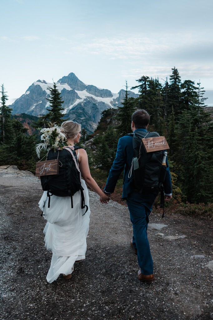 Bride and groom hike back down after their intimate North Cascades wedding ceremony