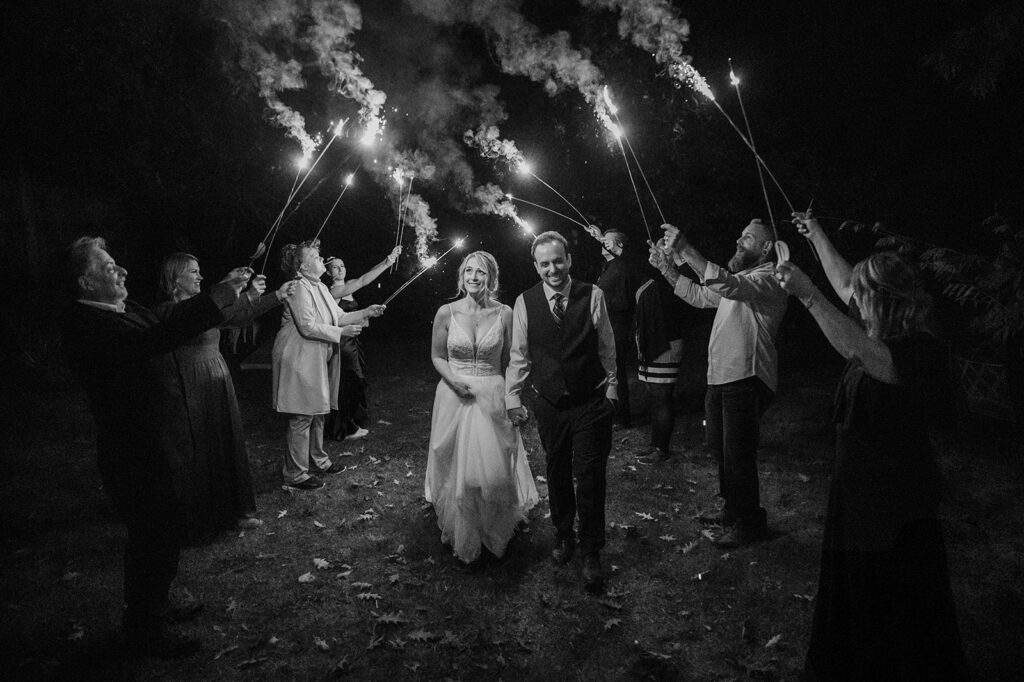 Family and friends light sparklers for their intimate North Cascades wedding reception