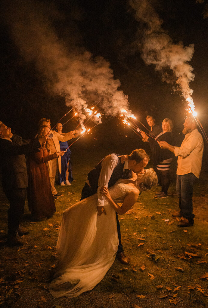 Family and friends light sparklers for their intimate North Cascades wedding reception