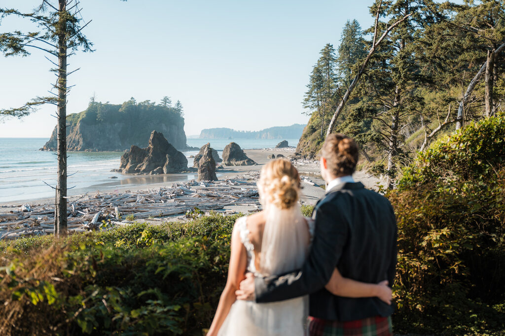 Bride and groom look out to Ruby Beach