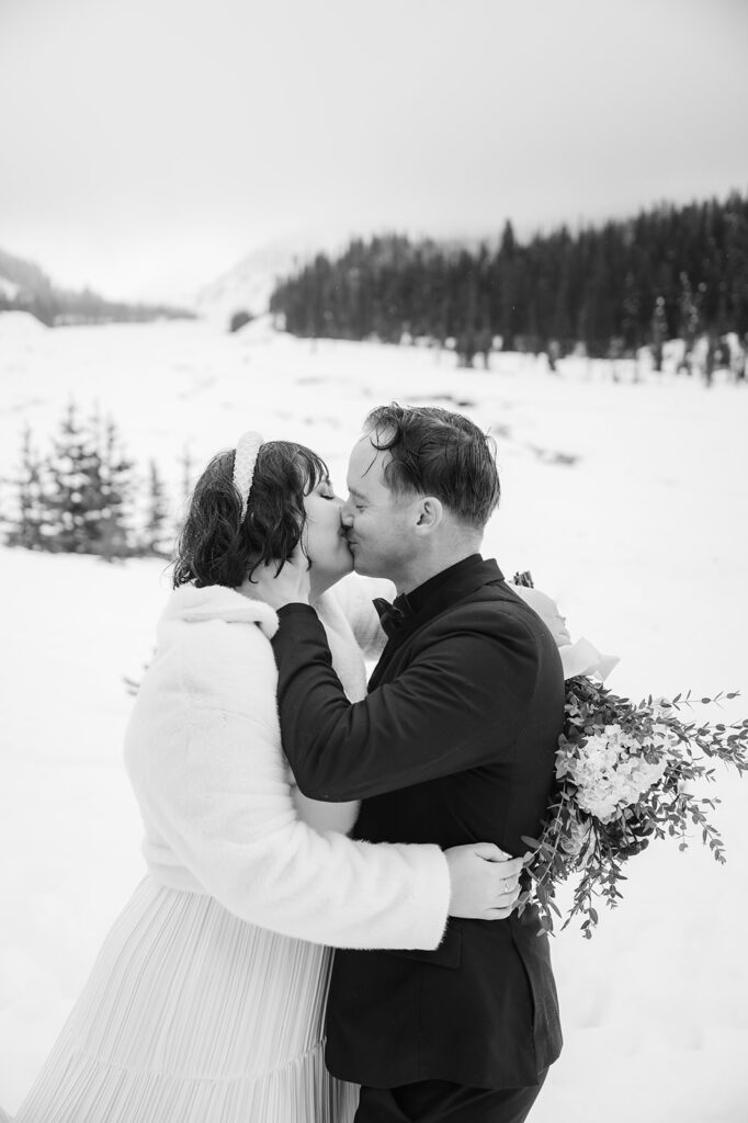 couple sharing their first kiss during their winter wedding day at Mount Hood Oregon