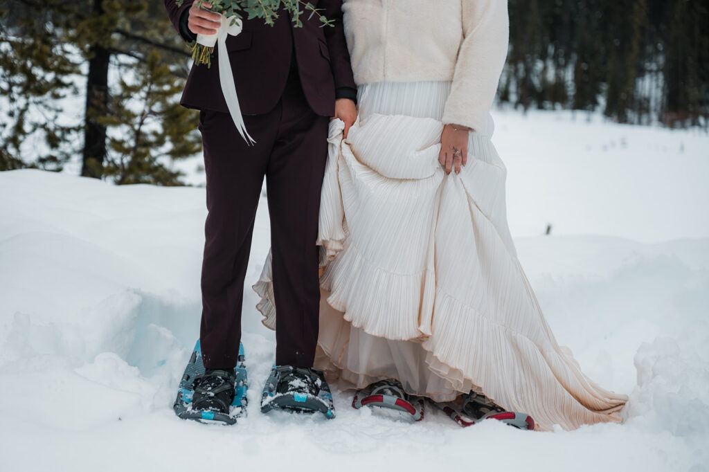 couple showing off their snowshoes during their winter elopement day at Mount Hood Oregon