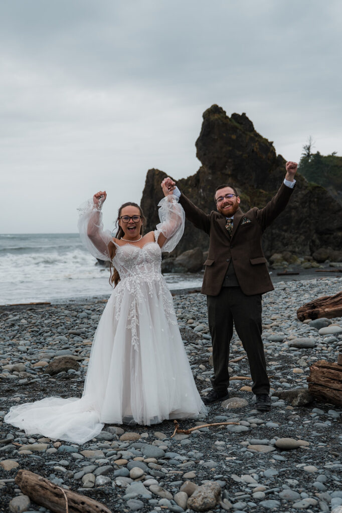Bride and groom exchanging vows at sunset on Ruby Beach, with their closest family members nearby and sea stacks in the background