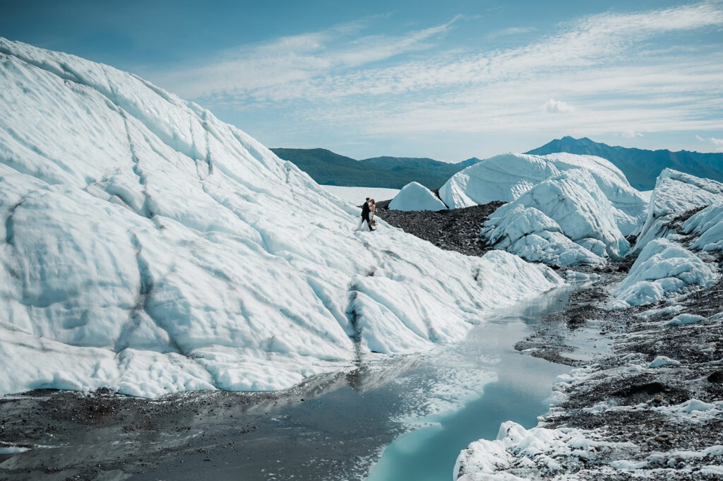 bride and groom walking around on the matanuska glacier during their alaska elopement day