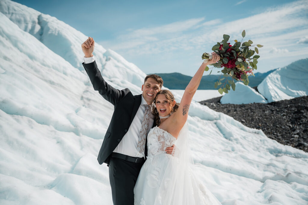 bride and groom cheering during their alaska glacier elopement 