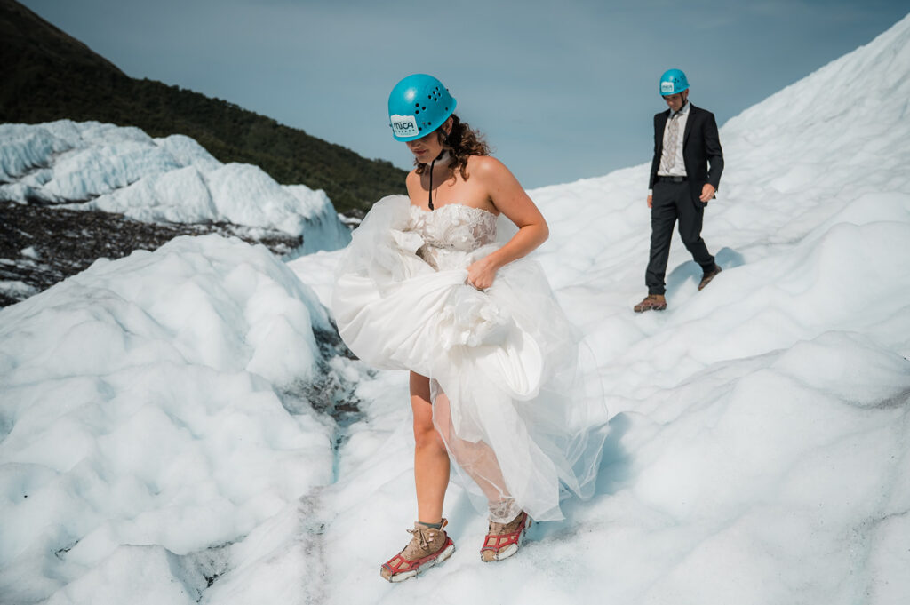 bride and groom walking on the matanuska glacier during their elopement day