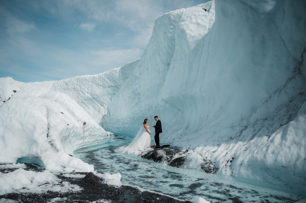 bride and groom exchanging vows on the glacier during their elopement day in Alaska