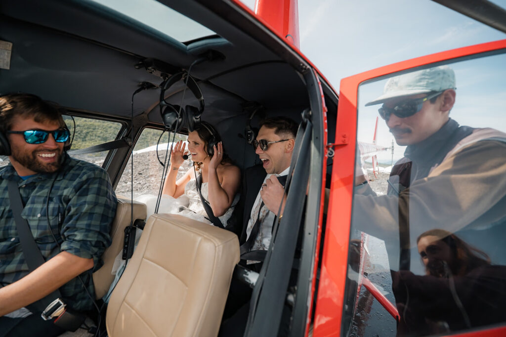bride and groom in a helicopter on their alaska elopement day