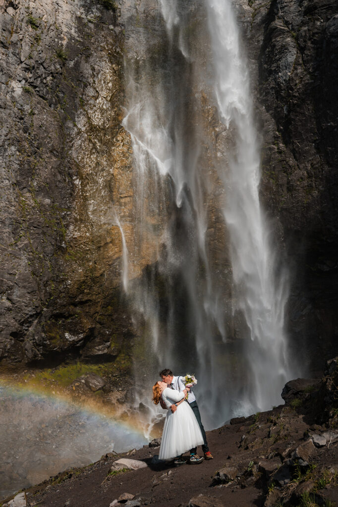 couple kissing in front of comet falls during their mt. rainier elopement day