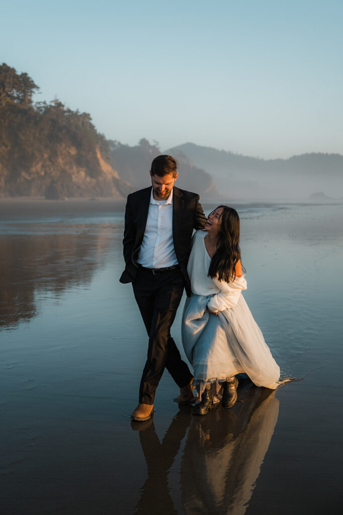couple having fun on the beach at hug point during their Oregon coast vow renewal