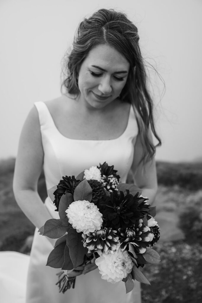 Bride posing in the alpine landscape on a cloudy day at Mt. Rainier